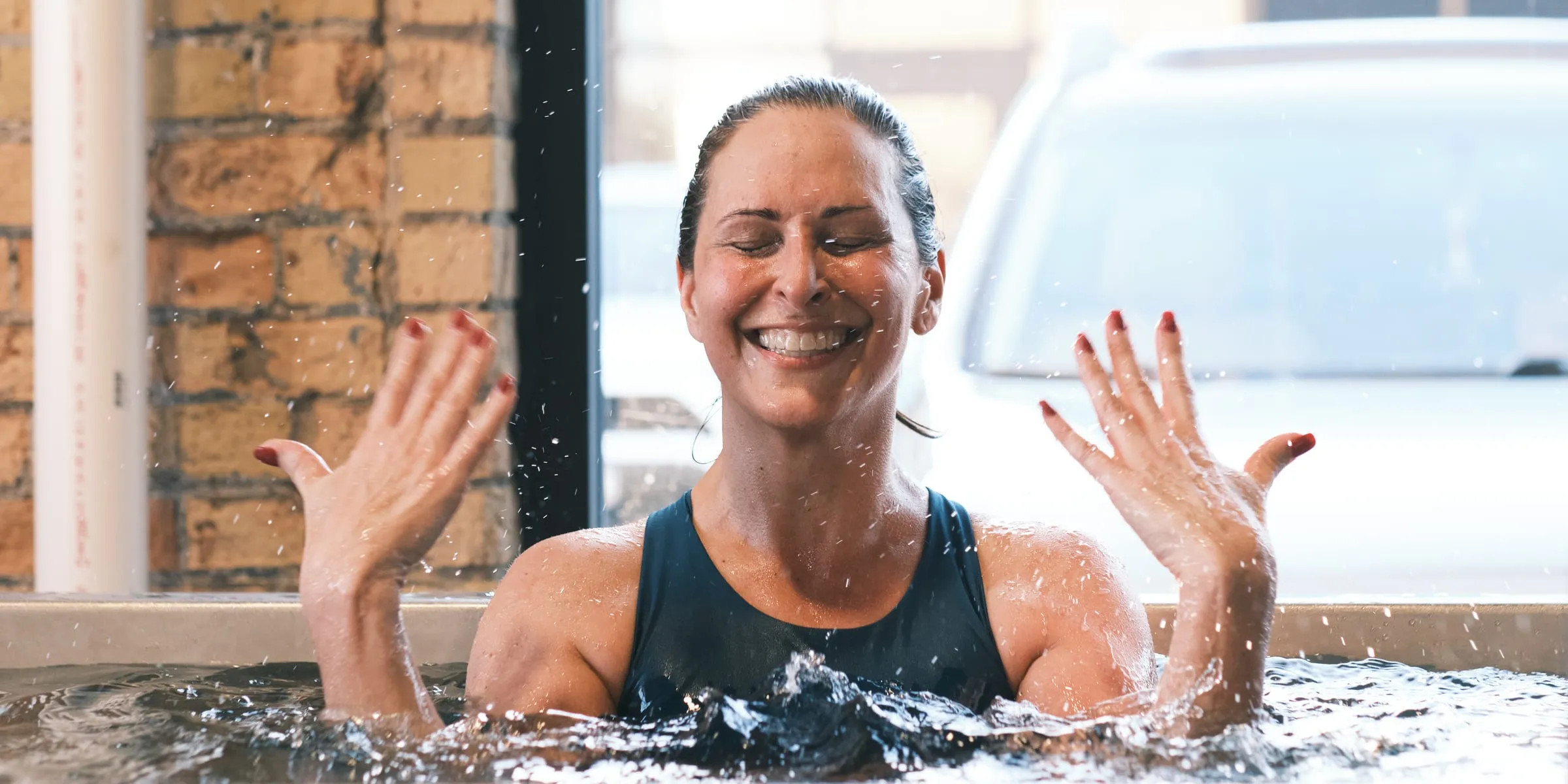 A member smiling in the cold plunge in Minneapolis